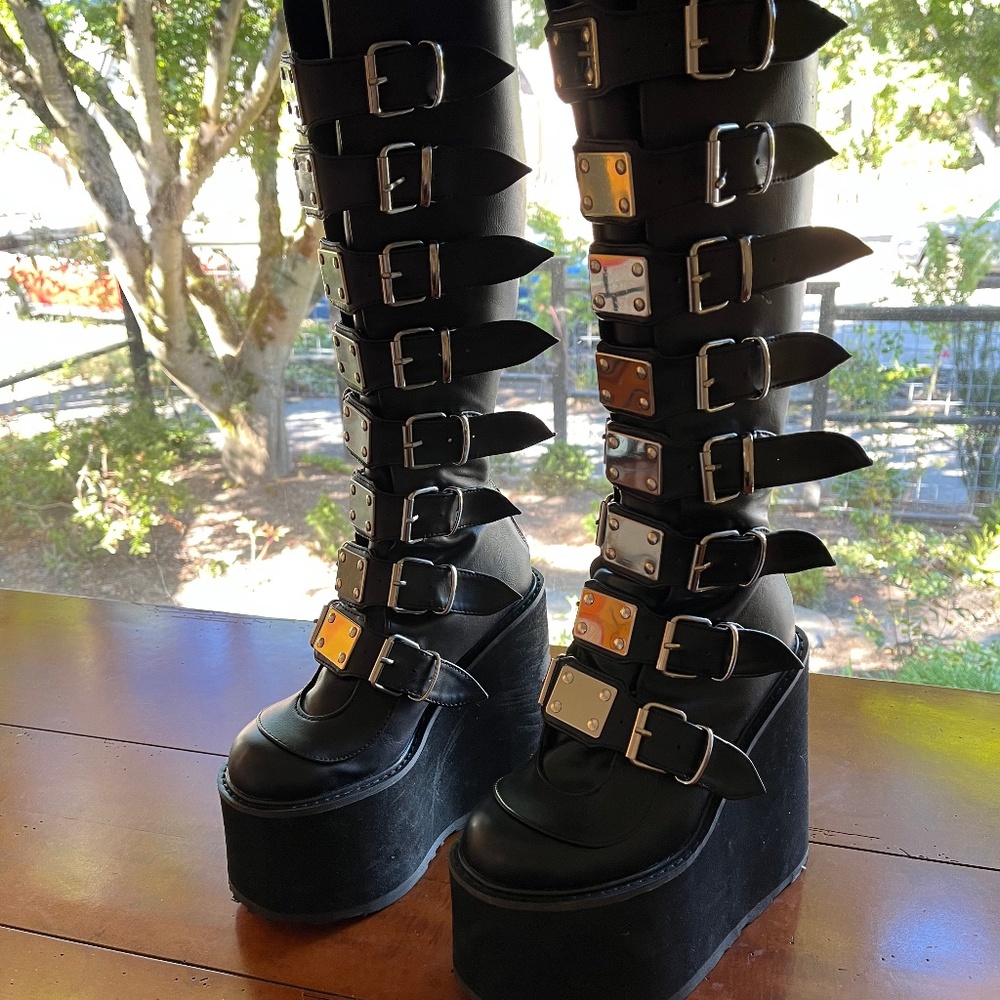 Black knee high boots with silver buckles